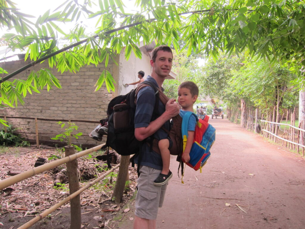 Carrying son in front and backpack in back on Gili Air, Indonesia