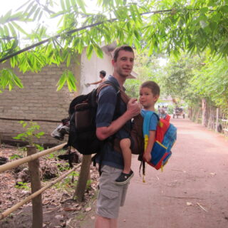 Carrying son in front and backpack in back on Gili Air, Indonesia