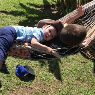 boys relaxing in hammock