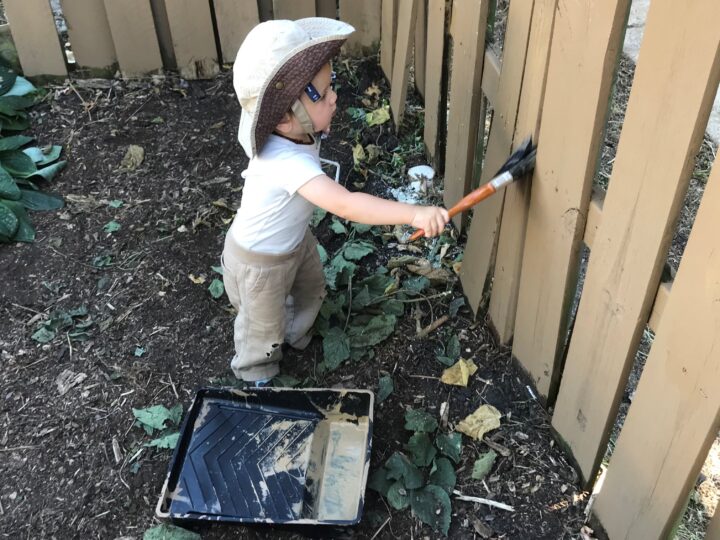 baby painting fence