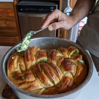 Putting butter on garlic bread