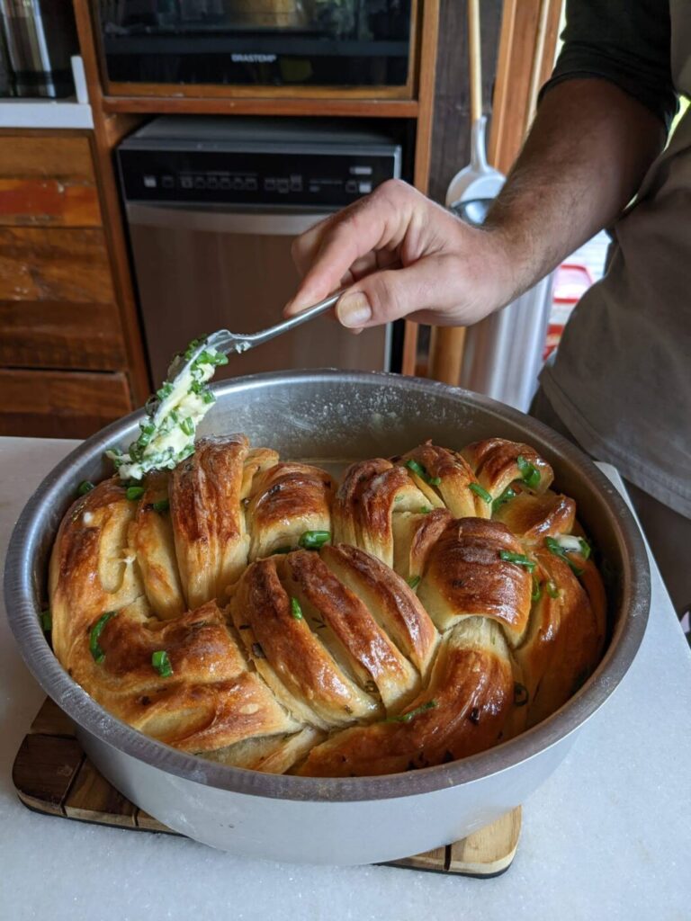 Putting butter on garlic bread